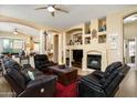 Open-concept living room with tile floors, a fireplace, and built-in display shelves at 9543 E Kiisa Dr, Scottsdale, AZ 85262