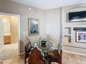Dining area with glass table and four chairs, featuring a view into the neighboring bathroom at 10401 N Saguaro Blvd # 123, Fountain Hills, AZ 85268