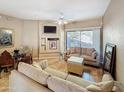 Inviting living room showcasing a cozy seating arrangement, ceiling fan, and a patio view at 10401 N Saguaro Blvd # 123, Fountain Hills, AZ 85268