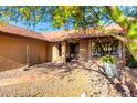 Attractive home entrance with a tiled walkway and desert landscaping under the shade of a tree at 13533 N 91St Way, Scottsdale, AZ 85260