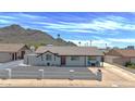 Inviting single-story home with a dark-colored rock driveway, quaint front yard, and a peaceful residential setting at 1511 E Carol Ave, Phoenix, AZ 85020