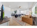Cozy living room featuring an open floor plan with a large sectional sofa, barn door, and access to the dining area at 1511 E Carol Ave, Phoenix, AZ 85020