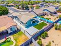 Aerial view of a cozy backyard featuring artificial turf, covered patio, and privacy fence for outdoor entertaining at 1550 W Saint Kateri Dr, Phoenix, AZ 85041