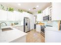 Modern kitchen with white cabinets, stainless steel appliances, granite countertops, and ample storage space at 1550 W Saint Kateri Dr, Phoenix, AZ 85041