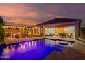 Backyard oasis featuring a sparkling pool, covered patio, and plenty of space for entertaining at 15665 W Coronado Rd, Goodyear, AZ 85395