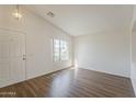 Bright living room featuring wood-look floors and natural lighting at 15962 W Gibson Ln, Goodyear, AZ 85338