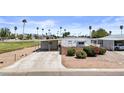 Charming home with a long driveway, small garden area, and well-maintained lawn at 1641 S Sossaman Rd, Mesa, AZ 85209