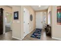 Welcoming entryway with light wood floors, neutral walls, and stylish decor at 16466 W Lariat Ln, Surprise, AZ 85387