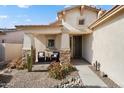 Inviting front porch with comfortable seating, decorative plants, and a stylish front door at 16466 W Lariat Ln, Surprise, AZ 85387
