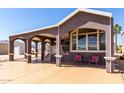 Cozy home featuring a covered carport, front porch area, and picturesque windows at 17200 W Bell Rd # 1202, Surprise, AZ 85374