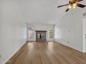 Bright living room featuring light wood floors and a classic brick fireplace at 17838 N 45Th Ave, Glendale, AZ 85308
