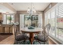 Cozy dining area featuring a round table, shuttered windows, and stylish chandelier at 1808 E Hayward Ave # 1, Phoenix, AZ 85020