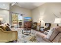 Inviting living room with cozy seating, a ceiling fan, and sliding glass doors to the patio at 19115 E Buckskin Ct, Rio Verde, AZ 85263