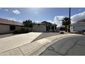 Single-story home features a front yard with desert landscaping and a spacious driveway at 19976 N 63Rd Dr, Glendale, AZ 85308