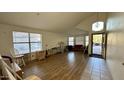 Open-concept living room with tile entry, wood flooring, and plenty of natural light at 19976 N 63Rd Dr, Glendale, AZ 85308