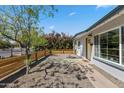 House exterior featuring desert landscaping, a wooden fence and mature trees at 2039 N 12Th St, Phoenix, AZ 85006