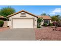 A well maintained single-story home featuring a neutral-toned exterior, desert landscaping and a two-car garage at 20717 N 104Th Ln, Peoria, AZ 85382