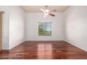 Bright bedroom with hardwood floors, ceiling fan, and a large window that provides great views at 20801 N 90Th Pl # 210, Scottsdale, AZ 85255