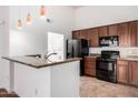 Modern kitchen features granite countertops, stainless steel appliances, and ample cabinet space at 20801 N 90Th Pl # 210, Scottsdale, AZ 85255