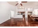 Open-concept living room and kitchen with sleek hardwood floors and plenty of natural light at 20801 N 90Th Pl # 210, Scottsdale, AZ 85255