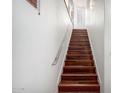 A modern staircase with sleek metal railing ascends alongside a bright white wall at 20801 N 90Th Pl # 210, Scottsdale, AZ 85255