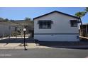 Charming home exterior with awnings, carport, and desert landscaping at 2233 E Behrend Dr # 211, Phoenix, AZ 85024