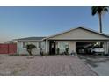 Charming single-story home with well-maintained landscaping, a covered carport, and appealing curb appeal at 2459 E Baltimore St, Mesa, AZ 85213