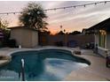 Relaxing backyard pool with desert landscaping and vibrant sunset at 2459 E Baltimore St, Mesa, AZ 85213