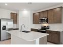 Modern kitchen featuring stainless steel appliances, a center island, and updated countertops at 25479 W Graham Trl, Buckeye, AZ 85326