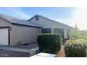 Exterior shot of a single-story home featuring a two-car garage and simple landscaping at 2618 S 81St Ln, Phoenix, AZ 85043