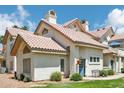 Charming home with a red tile roof, manicured lawn, and inviting blue front door at 2801 N Litchfield Rd # 37, Goodyear, AZ 85395