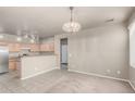 Open living area with carpet flooring, neutral walls, and adjacent kitchen at 3706 E Yeager Dr, Gilbert, AZ 85295