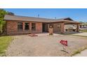Charming brick home featuring a covered carport and inviting front entrance at 4349 W Morten Ave, Glendale, AZ 85301