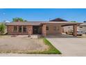 Inviting single-story home featuring brick accents and a convenient covered carport at 4349 W Morten Ave, Glendale, AZ 85301