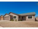 Single-story tan home with two car garage and gravel yard at 4542 N 86Th Dr, Phoenix, AZ 85037