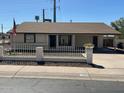 Inviting single-story home featuring a tidy front yard and a quaint white fence at 4716 S Fair Nw Ln, Tempe, AZ 85282