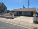 Charming single-story home with a well-manicured front yard and inviting driveway at 4716 S Fair Nw Ln, Tempe, AZ 85282