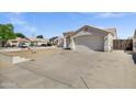 Single Gathering home featuring a large front yard, tile roof, block wall, and two car garage at 5046 W Monte Cristo Ave, Glendale, AZ 85306