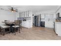 Bright and airy kitchen with modern appliances, white cabinets, and a dining area at 654 W Plata Ave, Mesa, AZ 85210