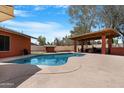 Inviting swimming pool and a covered patio providing shade and seating for outdoor enjoyment at 654 W Plata Ave, Mesa, AZ 85210