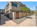 Townhome exterior with private entry and xeriscape landscaping with gated front patio area at 7464 E Paraiso Dr, Scottsdale, AZ 85255