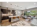 Open-concept kitchen and living room with modern finishes and large windows to outdoor patio at 7464 E Paraiso Dr, Scottsdale, AZ 85255
