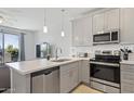Modern kitchen with stainless steel appliances, subway tile backsplash, and quartz countertops at 7531 E Billings St # 116, Mesa, AZ 85207