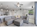 Bright living room featuring a comfortable gray sectional sofa and an open floor plan at 7531 E Billings St # 116, Mesa, AZ 85207