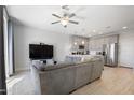 Inviting living room showcases a large TV and view of the stylish, open kitchen at 7531 E Billings St # 116, Mesa, AZ 85207