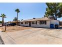 Well-kept single-story home with a spacious driveway and drought tolerant landscaping at 8111 E Jerome Ave, Mesa, AZ 85209