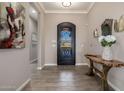 Warm and inviting foyer with decorative iron door, neutral walls, tile floors, and elegant rustic console table at 9059 E Leonora St. St, Mesa, AZ 85207