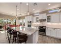 Bright kitchen with large island, granite countertops, stainless appliances, and adjacent dining area at 9059 E Leonora St. St, Mesa, AZ 85207