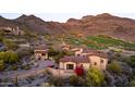 Beautiful desert home with red tile roof, landscaped grounds, and scenic mountain views, seamlessly blending luxury at 9820 E Thompson Peak Pkwy # 628, Scottsdale, AZ 85255