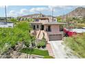 Beautiful home with landscaped front yard, cacti, rock features and a two-car garage at 12 E Foothill Dr, Phoenix, AZ 85020
